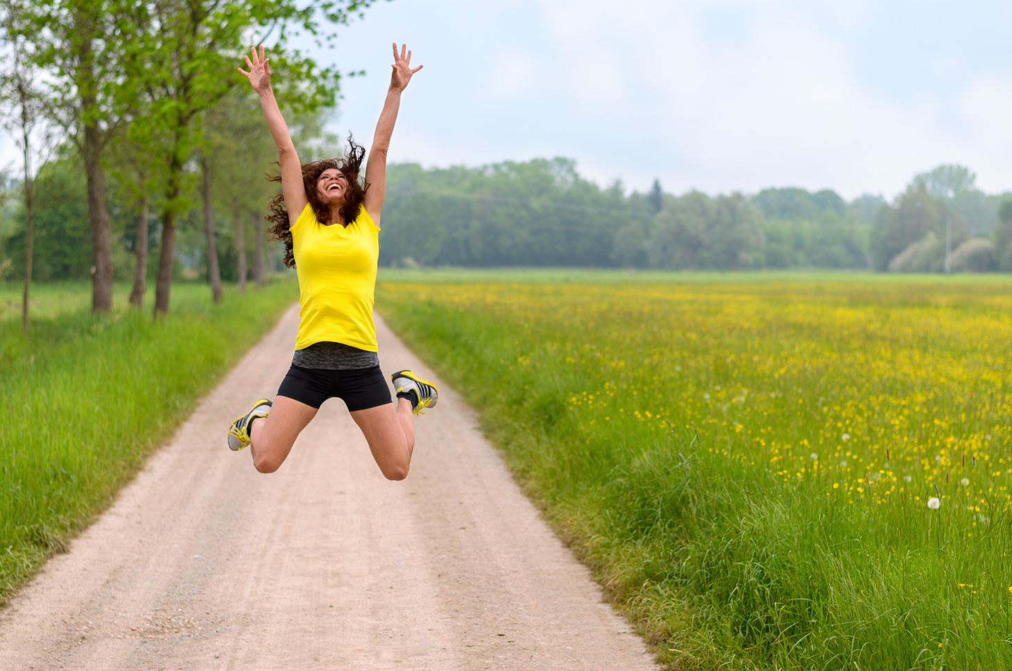 Energetic agile young woman leaping for joy